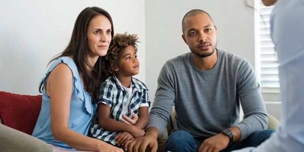 A family attentively listening to a person.