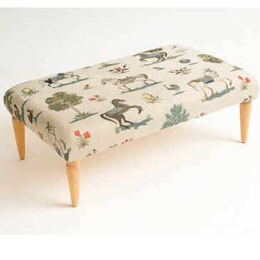 Wooden-legged bench with horse and nature print upholstery.