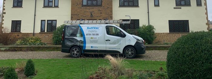GuttVac van and IPAF cherry picker outside a residential property in Northampton