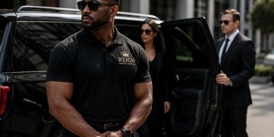 Two bodyguards professionally securing a woman exiting a black SUV in a city.