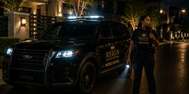Security guard standing near a patrol vehicle at night on a residential street.
