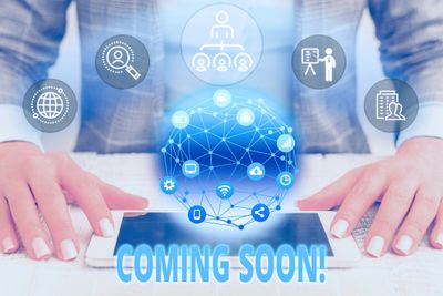 Hands using a tablet with digital network icons and "COMING SOON!" text.