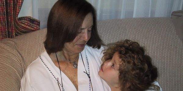 Grandma Segal smiling and looking down at child Butch.