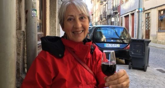 Elaine sipping a glass of ruby port in Porto Portugal.