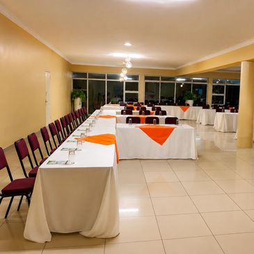 Banquet hall with tables and chairs arranged neatly.