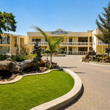 Exterior view of Lee's Inn hotel with garden and pathway.