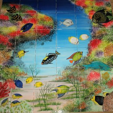 Ceramic tile mural of a coral reef with clownfish and other assorted marine life.