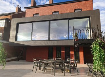 flat roof cantilevered steel, aluminium and glass extension with timber cladding in Southport