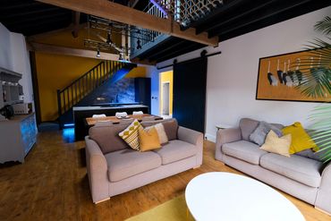 Exposed timber beams and mezzanine floor in converted Victorian warehouse in Southport