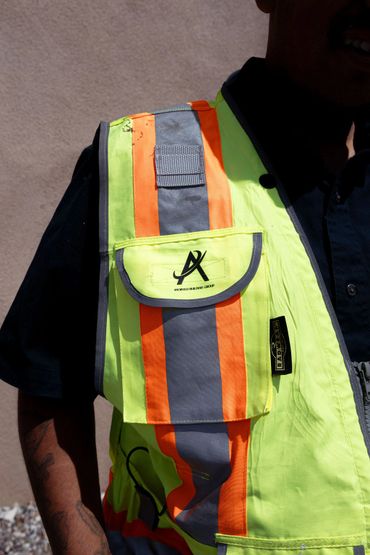 High-visibility safety vest with orange and gray reflective stripes.
