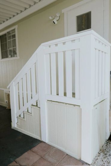 White wooden front porch railing and stairs.