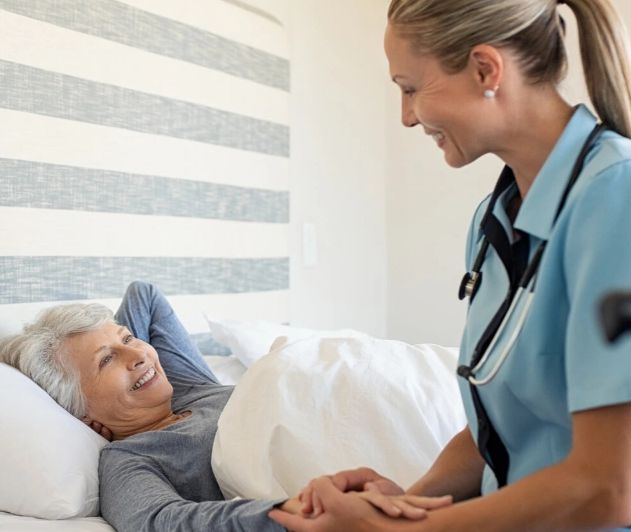 Nurse helping elderly patient get out of bed 