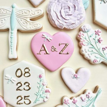 Decorative wedding-themed cookies with initials and date details.