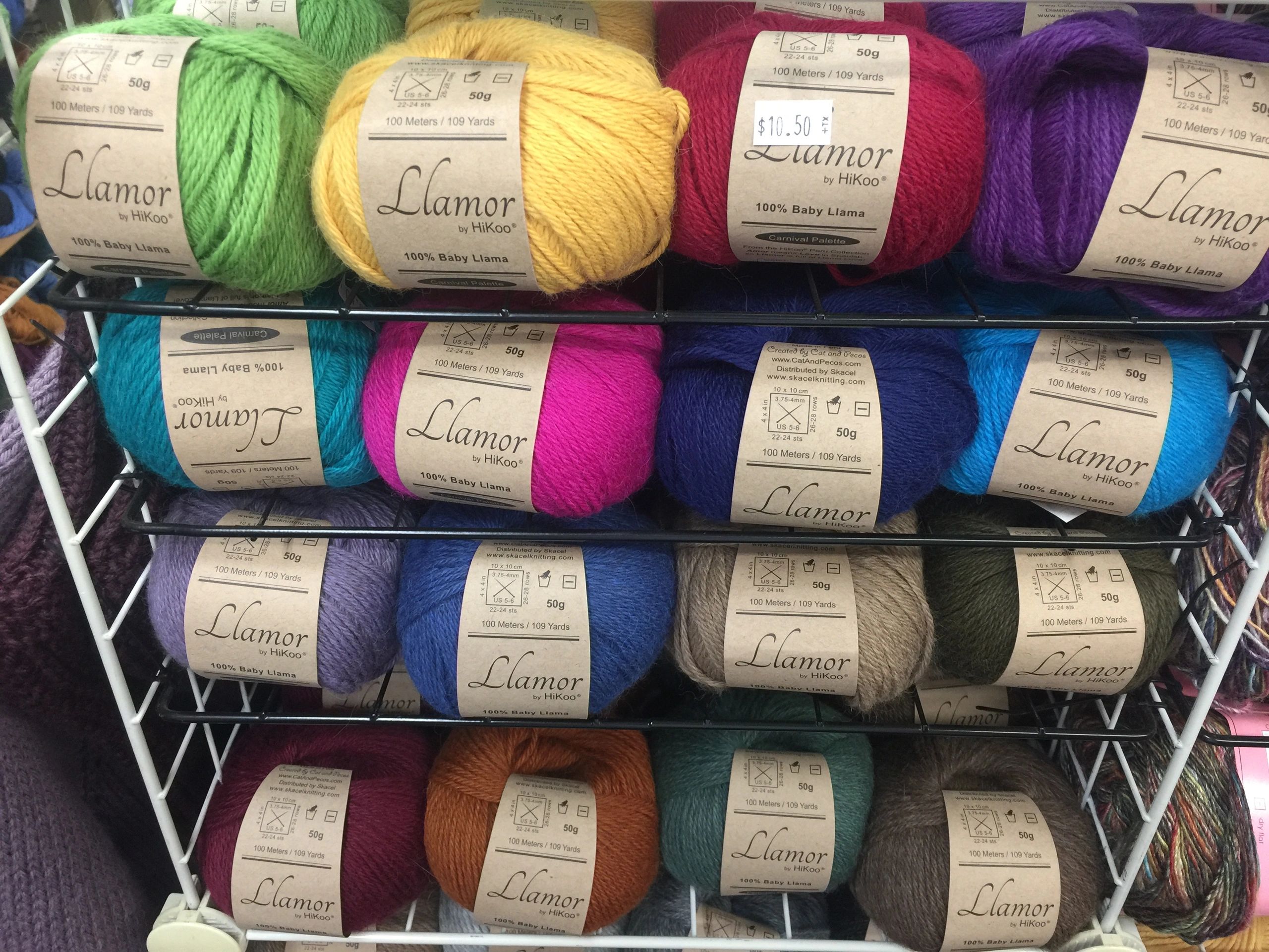 balls of yarn on shelves in various colors
