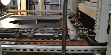 Various equipment available to meet client needs, including this sheet-fed vacuum former.