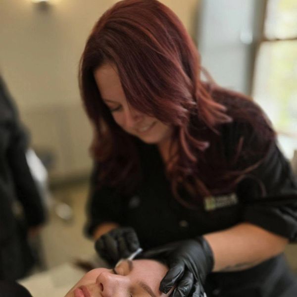 Woman giving a facial treatment.