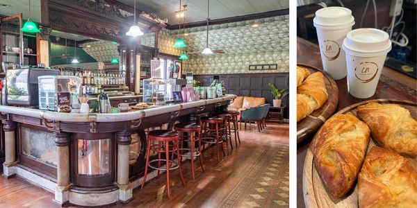 Vintage cafe interior with wooden bar and stools.