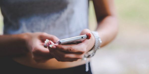 a woman keeping contact on her phone