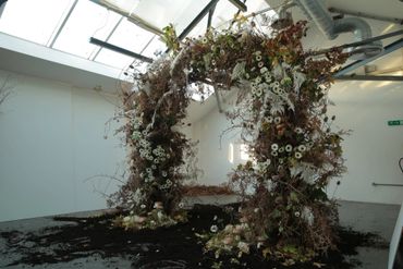 large floral arch made without floral foam using bracken, anemones, thistle and oakleaf.