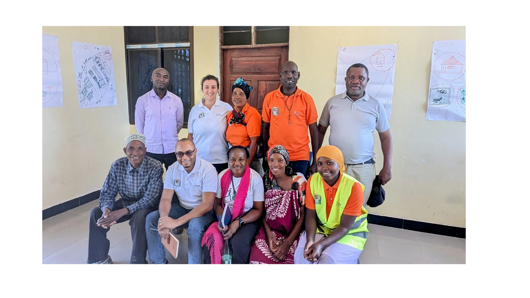 Three people seated at a table, reviewing documents together.