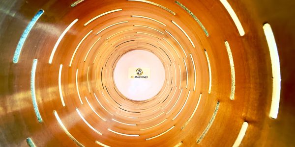 View inside a cylindrical wooden tube with light slits illuminating the interior.