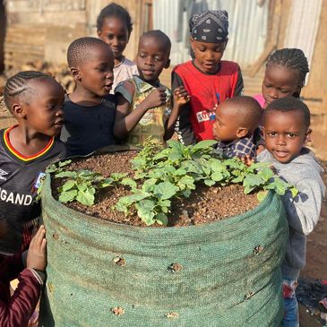 children gathered around a garden tower