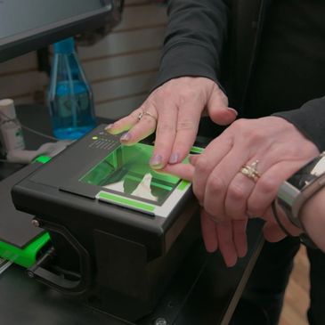 A person taking a woman biometrics 