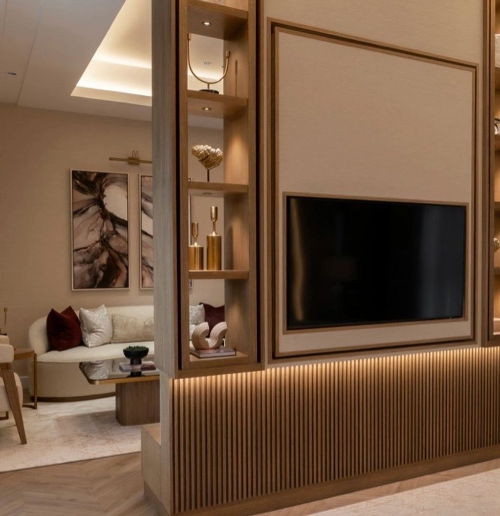 Modern living room with wooden TV unit and cozy seating area.
