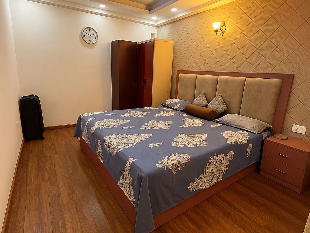 Cozy bedroom with wooden flooring and Installation in Gurgaon by Floor-O