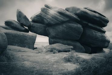 Large, oddly shaped rocks under a cloudy sky.