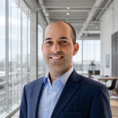 Smiling man in business attire in modern office.