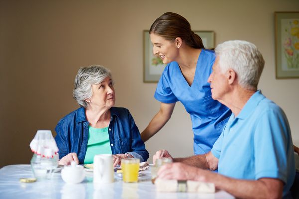 Shot of two residents and a nurse at a retirement home
