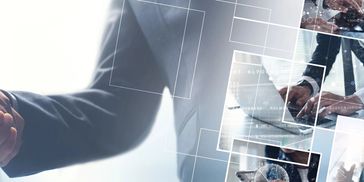 Business handshake with digital overlay and collaboration imagery.