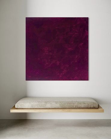 Minimalist bench with textured cushion beneath purple abstract art.
