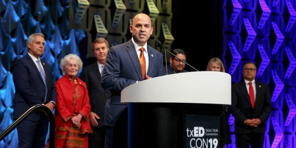 photo of speaker at a podium during a live convention event