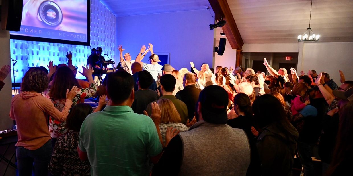 The congregation at Champion Life Church experiences an intimate moment of worship near the stage.