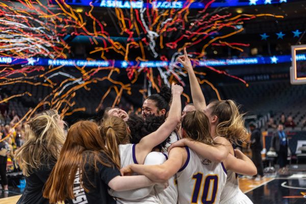 Women's basketball team celebrating a victory with confetti.