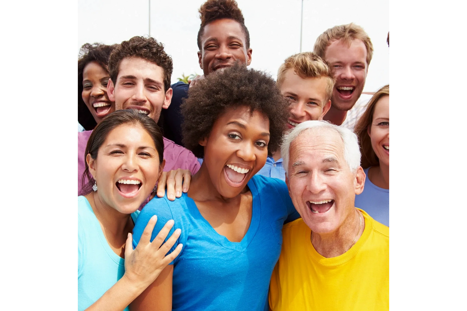 Group of people smiling with healthy teeth after dentist visit