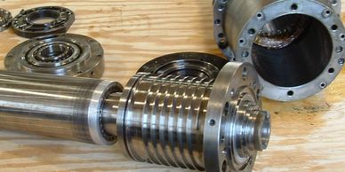Close-up of mechanical metal components on a wooden surface.
