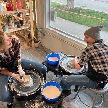Two people having a private pottery lesson