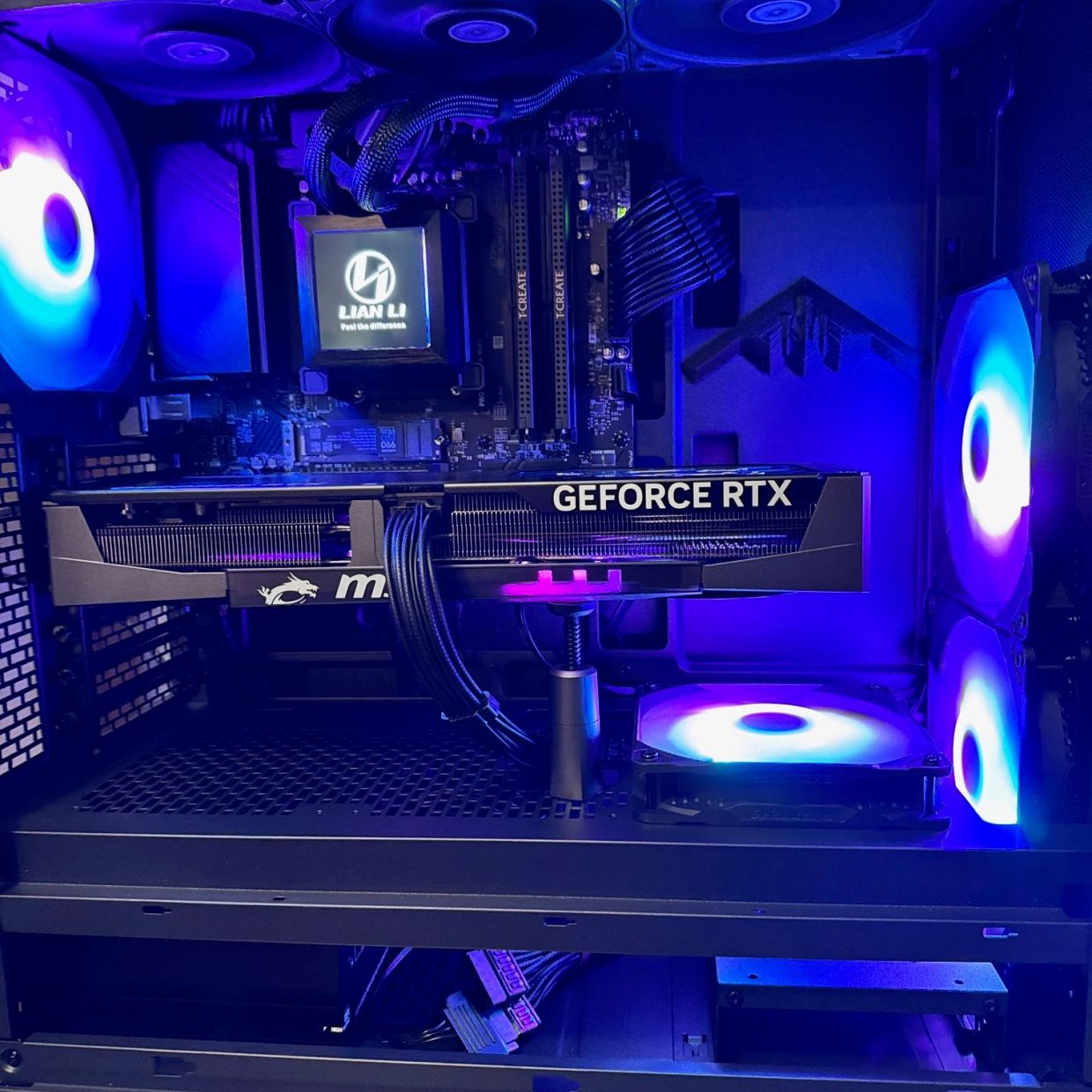 Custom-built gaming PC with illuminated GEFORCE RTX graphics card.