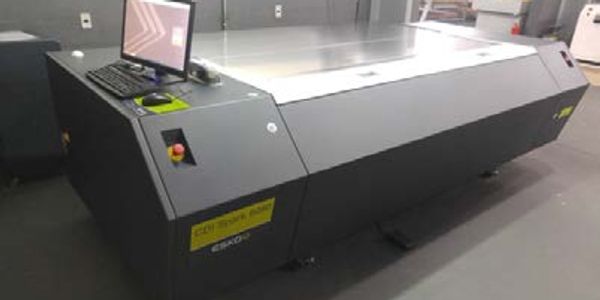 Large flatbed UV printer with control station.
