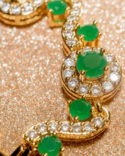 Emeralds surrounded by diamonds create a stunning look in jewelry