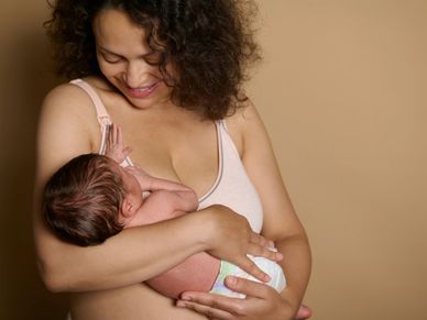 A mother lovingly breastfeeding her newborn baby.