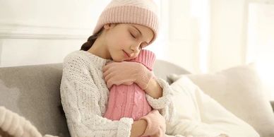 CHILD WITH HOT WATER BOTTLE