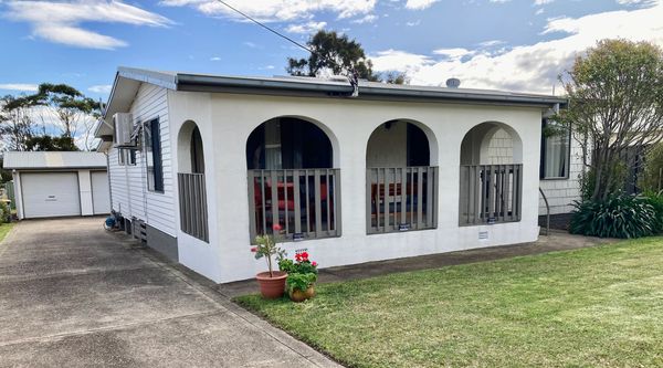 Arches • Culburra, a beach cottage and front lawn at Culburra Beach NSW.