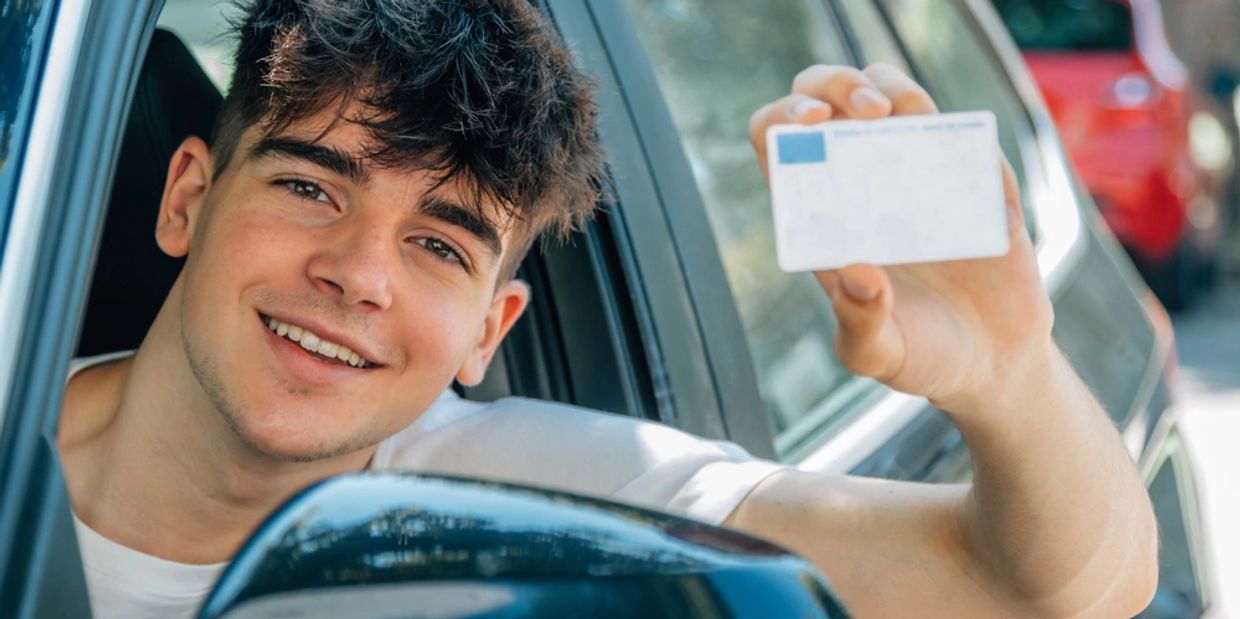 young nobel in the car with driver's license