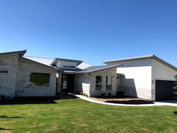 Clean grass front yard masonry walking trail 