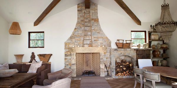 Cozy living space with stone fireplace and hardwood floors.