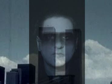 a transparent dream ghoul's head hovers over the horizon with two towers in the background.